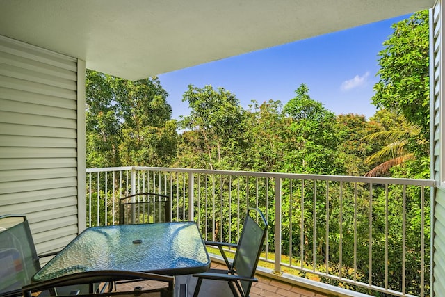 3811 Edward Rd Unit 1206, Princeville, HI 96722 - balcony with a forest view and outdoor dining area
