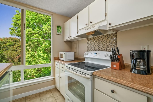 3811 Edward Rd Unit 1206, Princeville, HI 96722 - kitchen featuring white appliances, under cabinet range hood, healthy amount of natural light, backsplash, and a textured ceiling