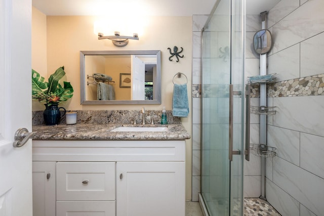 bathroom with vanity and a stall shower
