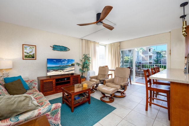 living room with a ceiling fan and light tile patterned floors