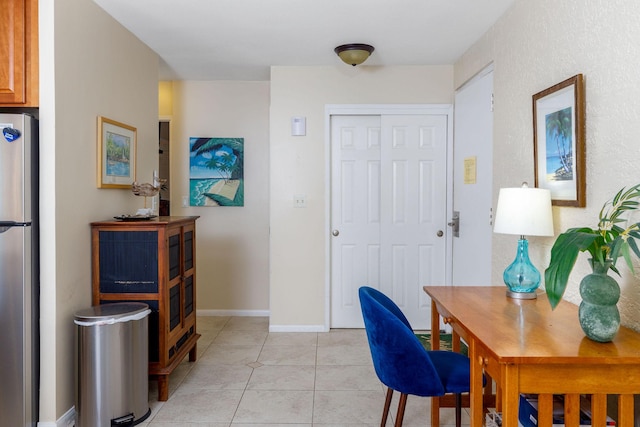 office area with light tile patterned floors and baseboards