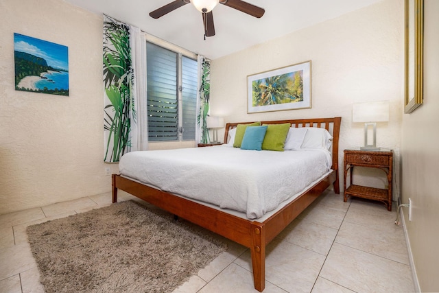 bedroom with baseboards, ceiling fan, and light tile patterned floors