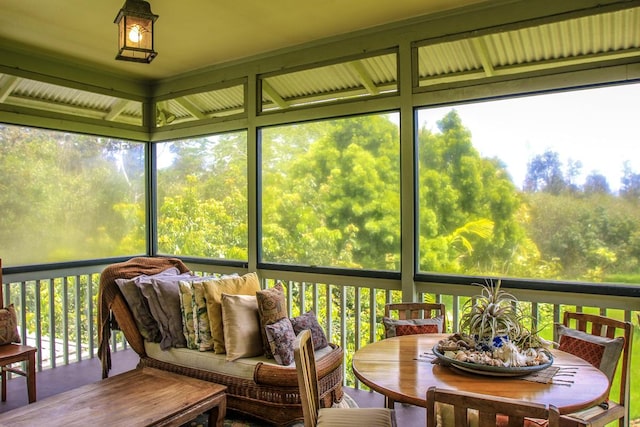 sunroom with outdoor dining area and plenty of natural light