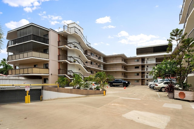 view of apartment building / complex with uncovered parking