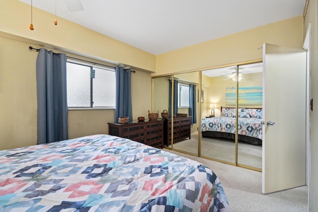 bedroom with carpet, multiple windows, and a closet