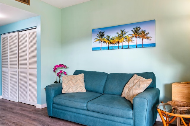 living room with dark wood-type flooring and baseboards