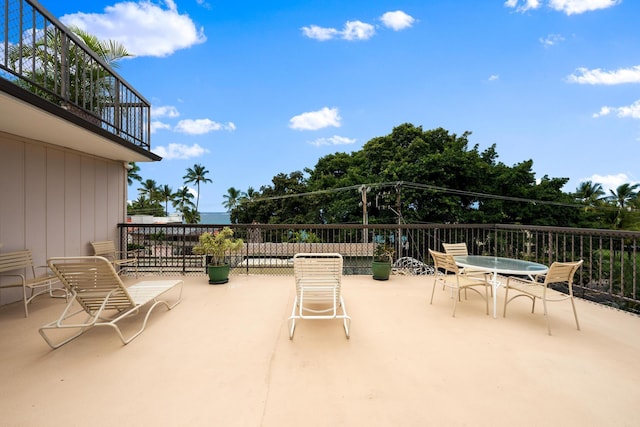 view of patio / terrace with a balcony and outdoor dining space