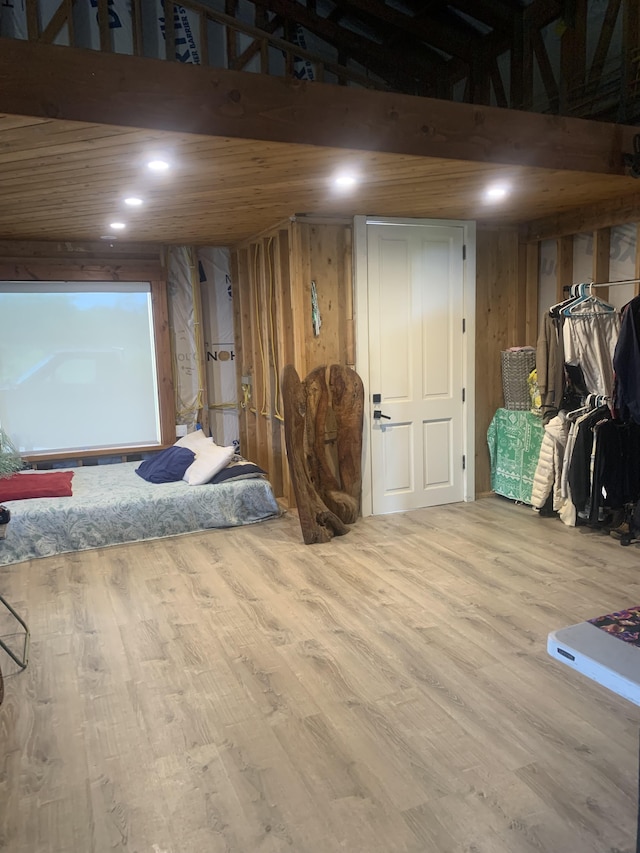 interior space featuring recessed lighting, wood finished floors, and wooden walls