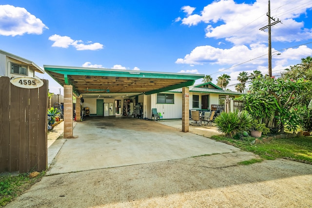 back of property featuring fence and driveway