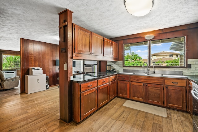 kitchen featuring a sink, tasteful backsplash, and a textured ceiling