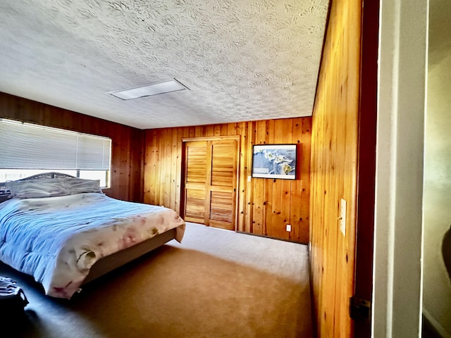 73-1228 Kaiminani Dr, Kailua-Kona, HI 96740 - bedroom featuring carpet floors, a textured ceiling, wood walls, and a closet