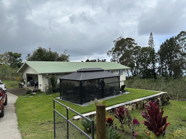 view of yard with a gazebo and concrete driveway