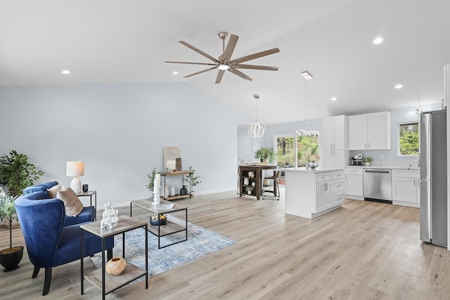 living area with a ceiling fan, healthy amount of natural light, light wood-style floors, recessed lighting, and high vaulted ceiling