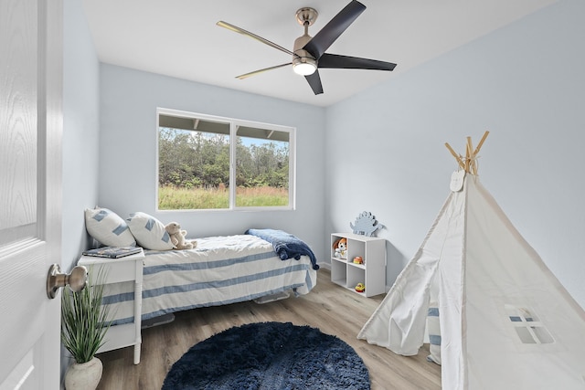 bedroom with wood finished floors and a ceiling fan