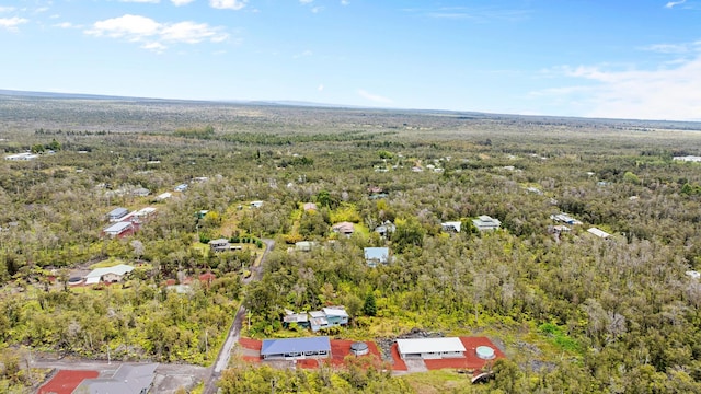 aerial view of property and surrounding area featuring a forest