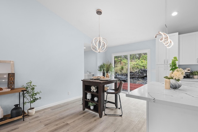 dining area with light wood finished floors, a chandelier, recessed lighting, and baseboards
