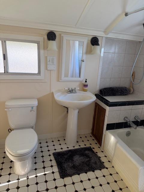 full bath featuring toilet, baseboards, and shower / bath combination