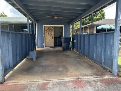 view of patio featuring fence and an attached carport