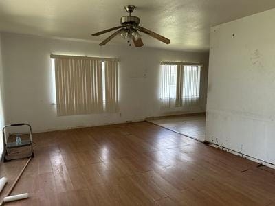 spare room with a ceiling fan and wood finished floors