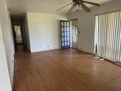 empty room featuring ceiling fan and wood finished floors