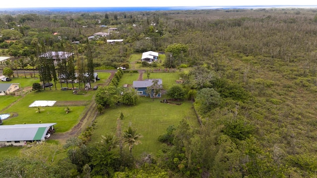 birds eye view of property featuring a forest view