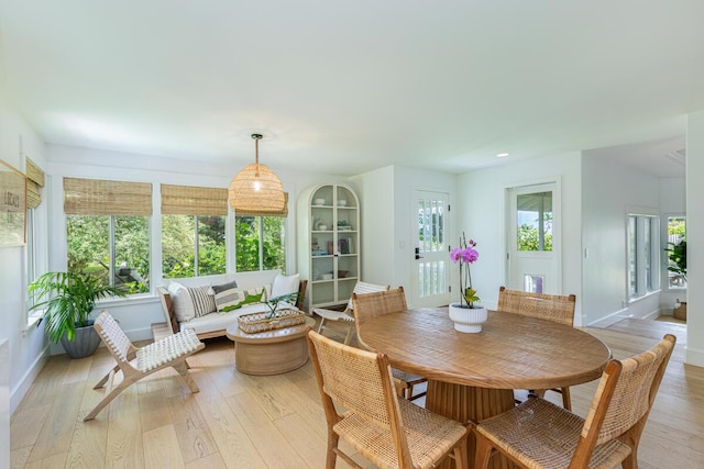 sunroom / solarium featuring wood finished floors, french doors, baseboards, and recessed lighting