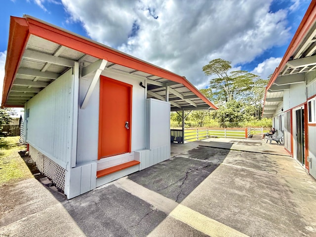 view of parking with fence