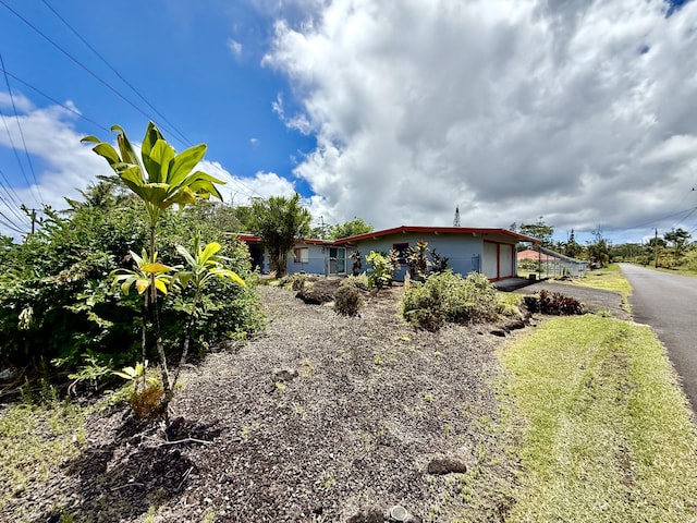 exterior space with aphalt driveway and a garage