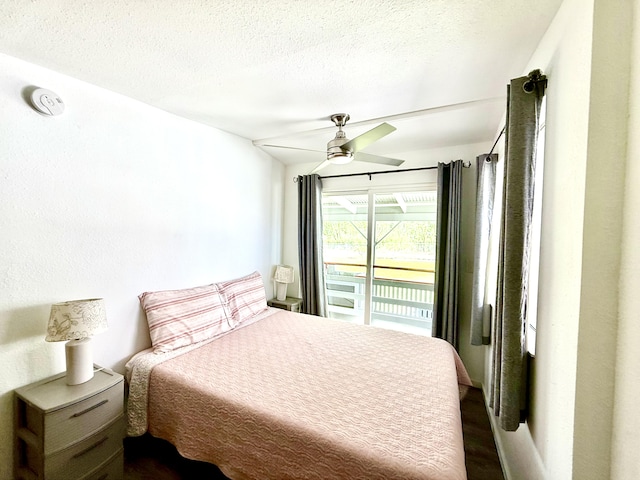 bedroom featuring dark wood-style flooring, access to exterior, and ceiling fan
