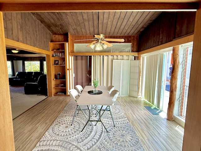 dining area featuring wooden walls, wood ceiling, and wood finished floors