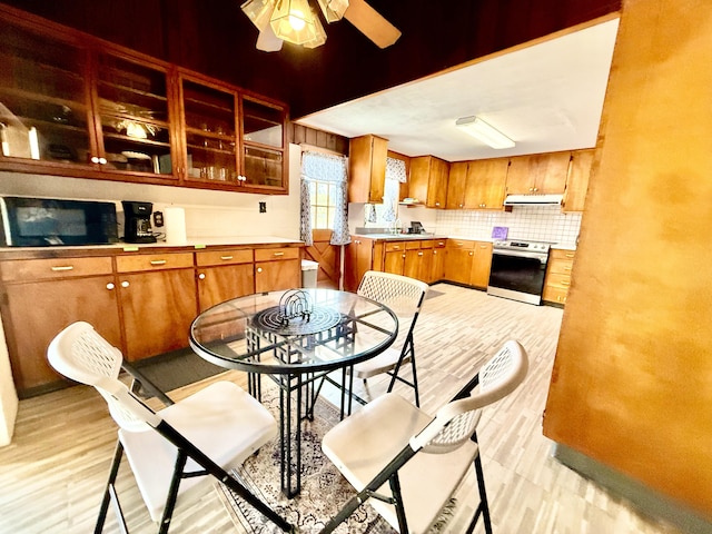 dining space with light wood-style flooring and a ceiling fan