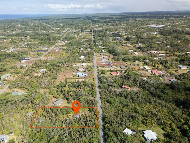 birds eye view of property with a wooded view