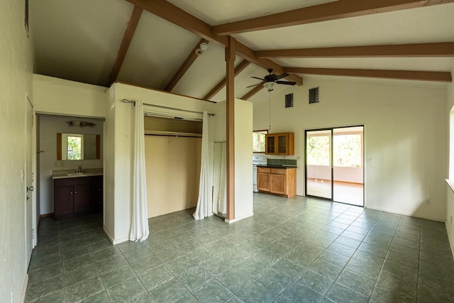 unfurnished bedroom with a sink, lofted ceiling with beams, a closet, visible vents, and baseboards