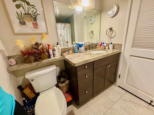 full bathroom featuring tile patterned flooring, toilet, and vanity