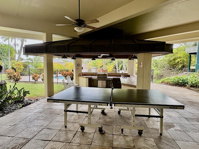 view of patio featuring an outdoor kitchen, ceiling fan, outdoor dining space, and a gazebo