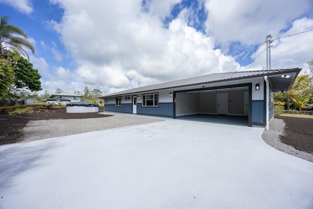 16-2074 Sandalwood Dr, Pahoa, HI 96778 - ranch-style house with concrete driveway, an attached garage, and metal roof