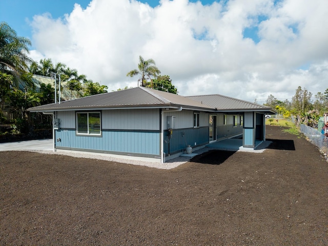 16-2074 Sandalwood Dr, Pahoa, HI 96778 - view of side of home with metal roof
