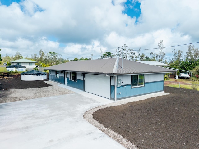 16-2074 Sandalwood Dr, Pahoa, HI 96778 - view of front of property featuring driveway, metal roof, and an attached garage