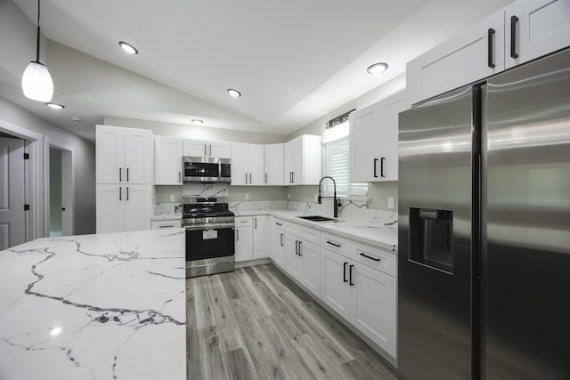 16-2074 Sandalwood Dr, Pahoa, HI 96778 - kitchen featuring appliances with stainless steel finishes, lofted ceiling, a sink, light stone countertops, and white cabinets