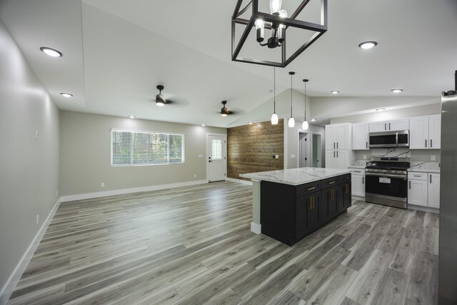 16-2074 Sandalwood Dr, Pahoa, HI 96778 - kitchen featuring stainless steel appliances, open floor plan, vaulted ceiling, white cabinets, and pendant lighting
