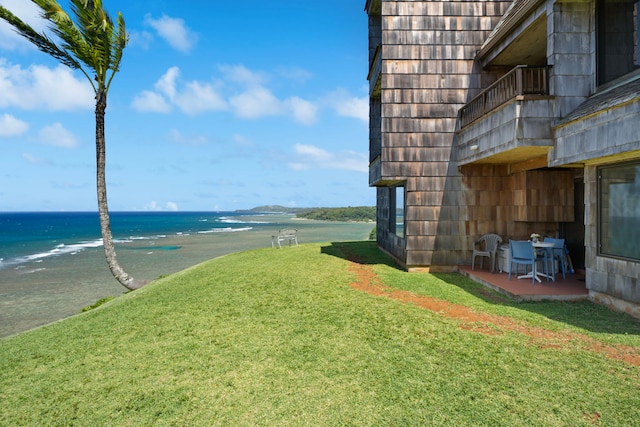 view of yard featuring a water view and a patio