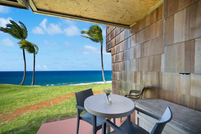 view of patio with a water view and a view of the beach