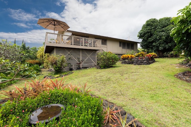 back of house featuring a yard and a deck