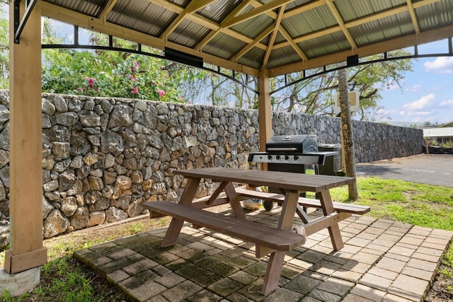view of patio / terrace with a gazebo, fence, and outdoor dining area
