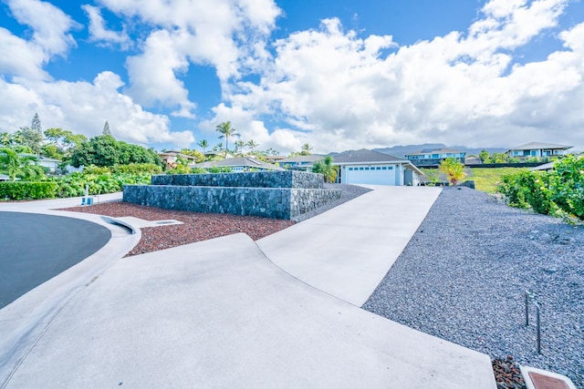 view of front of property featuring concrete driveway and a residential view