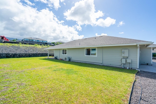 back of house featuring a yard