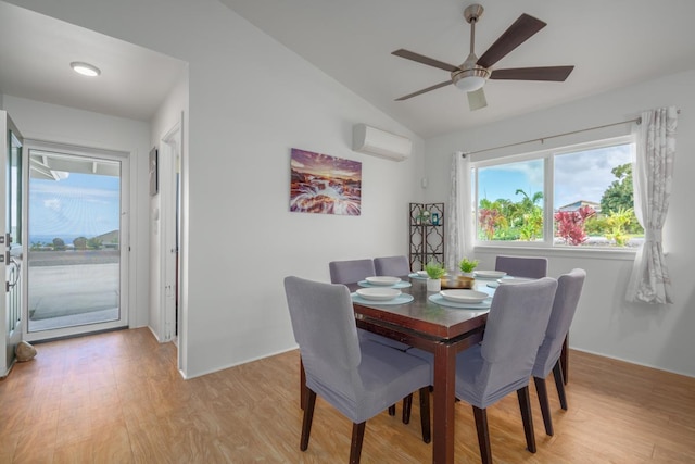 dining room featuring a wall mounted air conditioner, a ceiling fan, light wood-style flooring, and lofted ceiling
