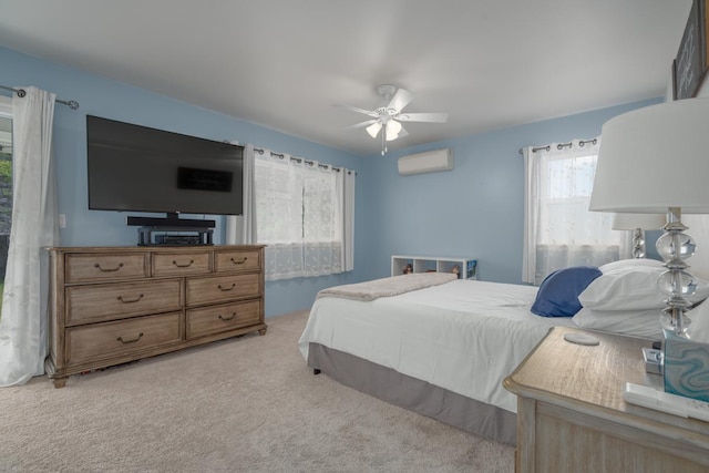 bedroom with a ceiling fan, light carpet, and a wall mounted air conditioner