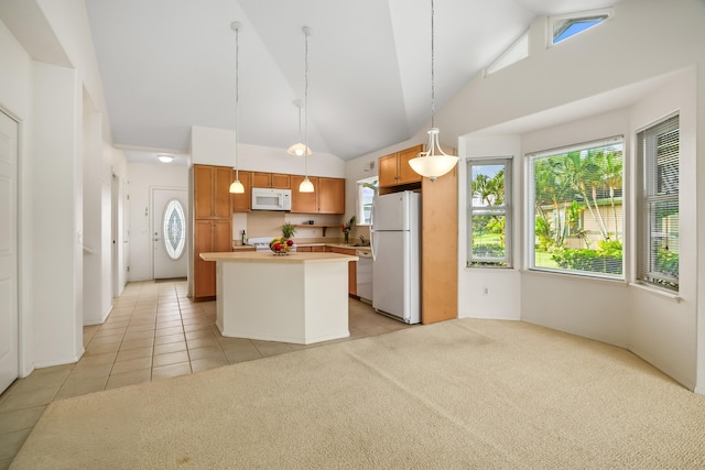 kitchen with white appliances, light tile patterned flooring, light countertops, a kitchen island, and high vaulted ceiling