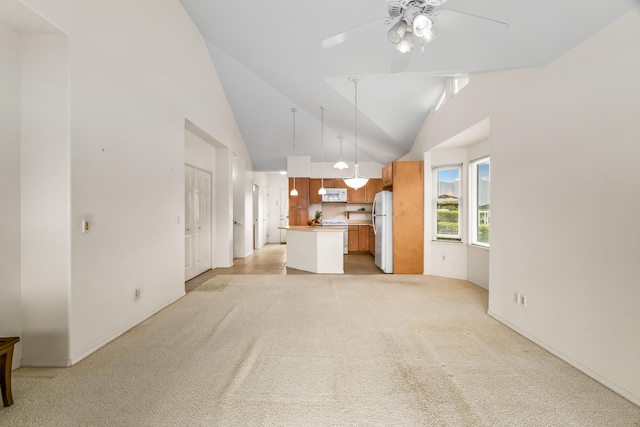 unfurnished living room featuring light carpet, a ceiling fan, vaulted ceiling, and baseboards